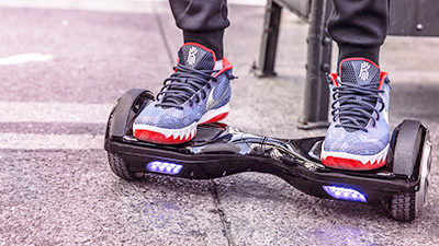 a close up of two feet standing on an hoverboard