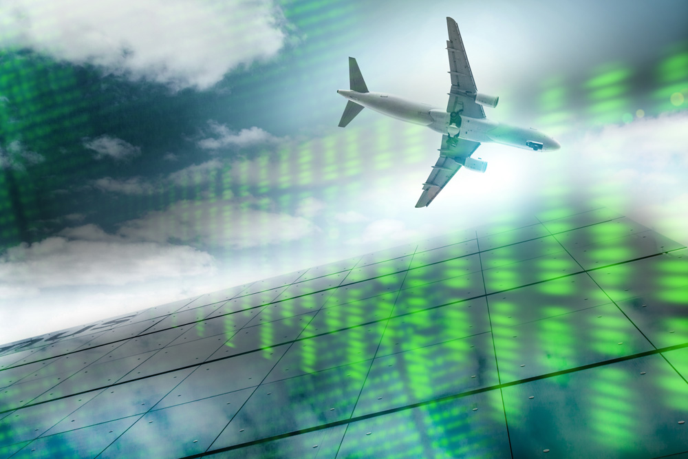 An aircraft flying, over an abstract background in green tones.